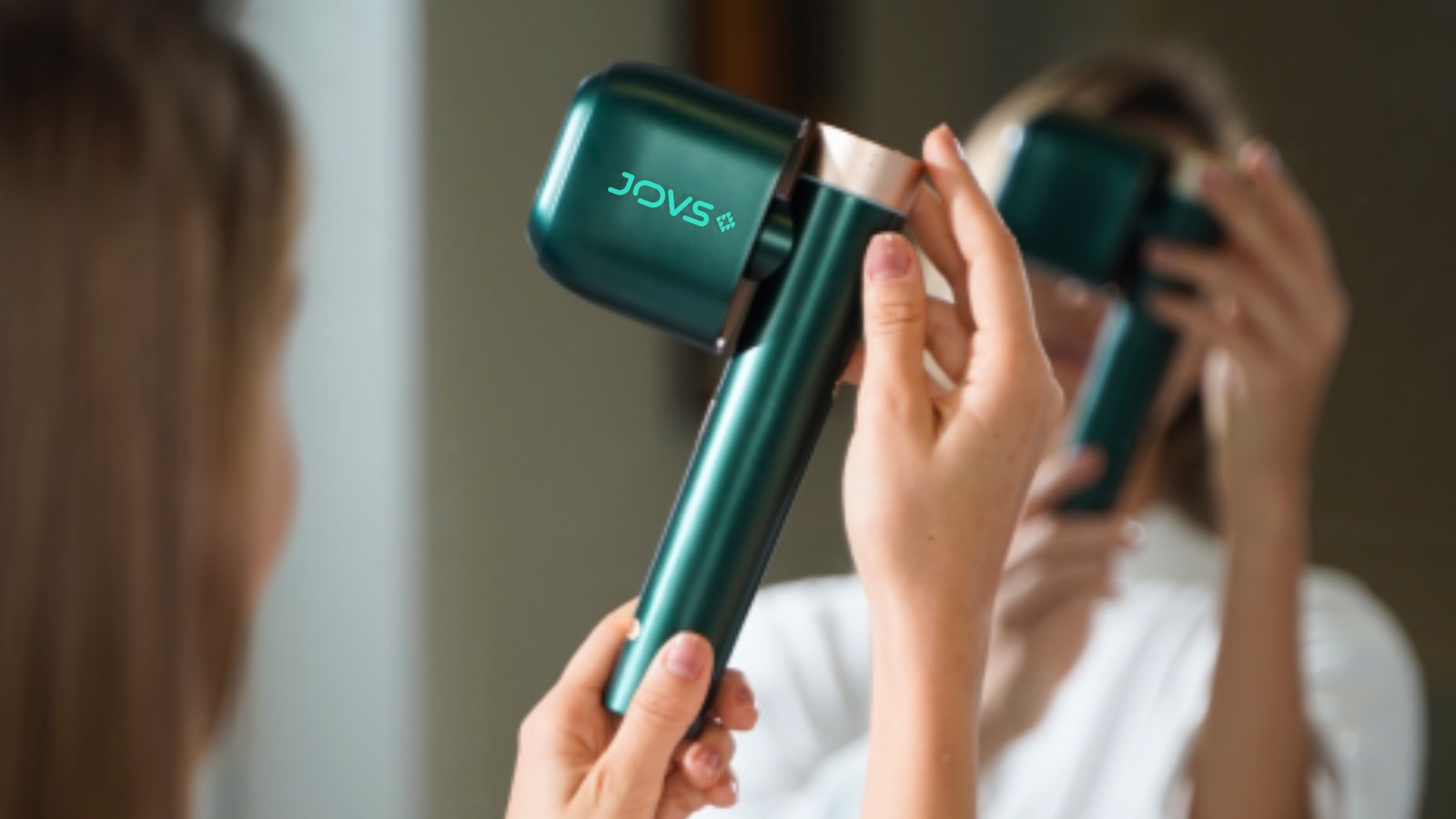 A woman blow drying her hair with a hair dryer